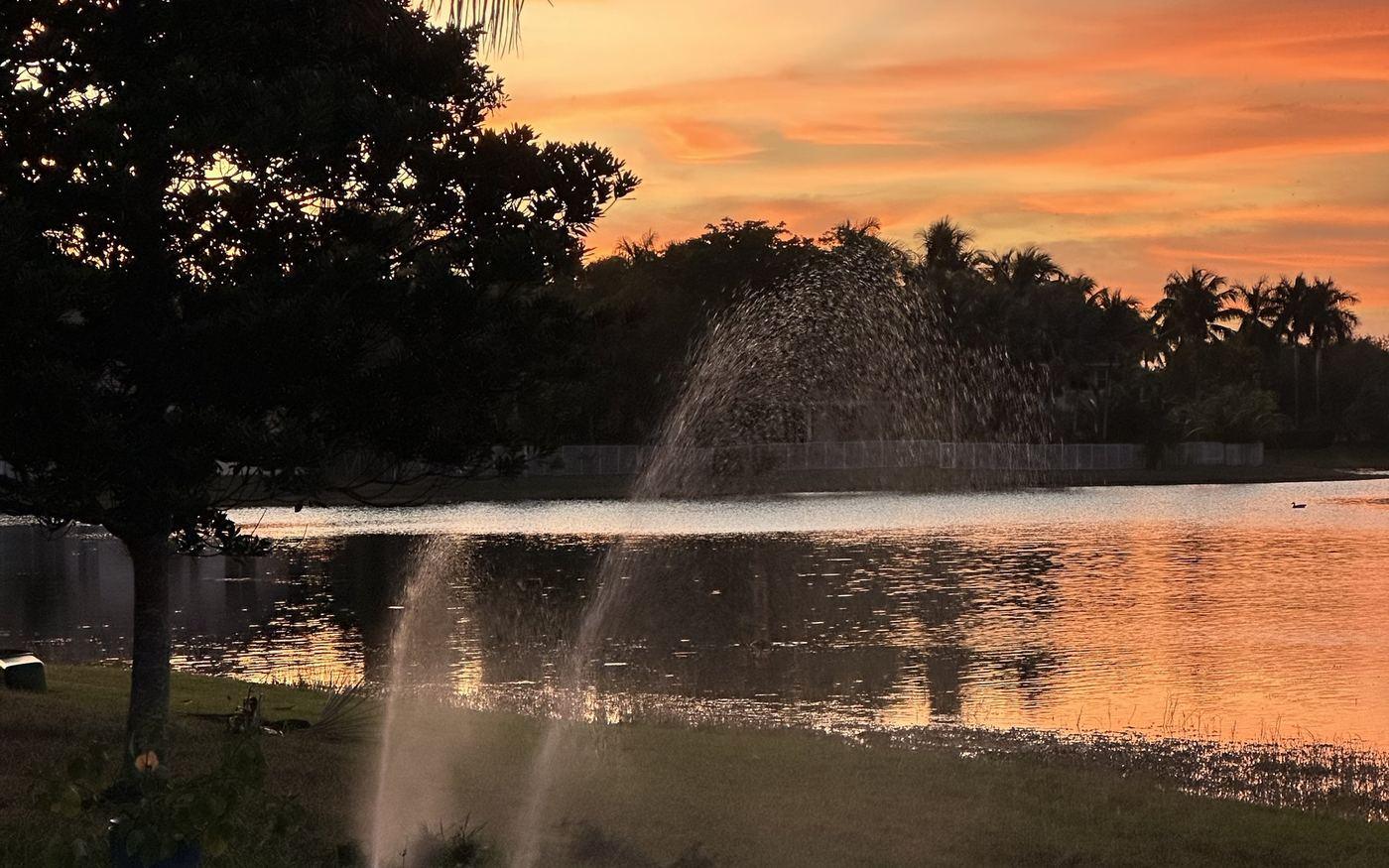 Irrigation drawing from a lake at sunset in Broward County