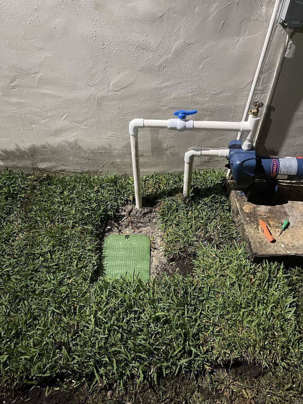 Completed irrigation job with valve box installed and grass restored