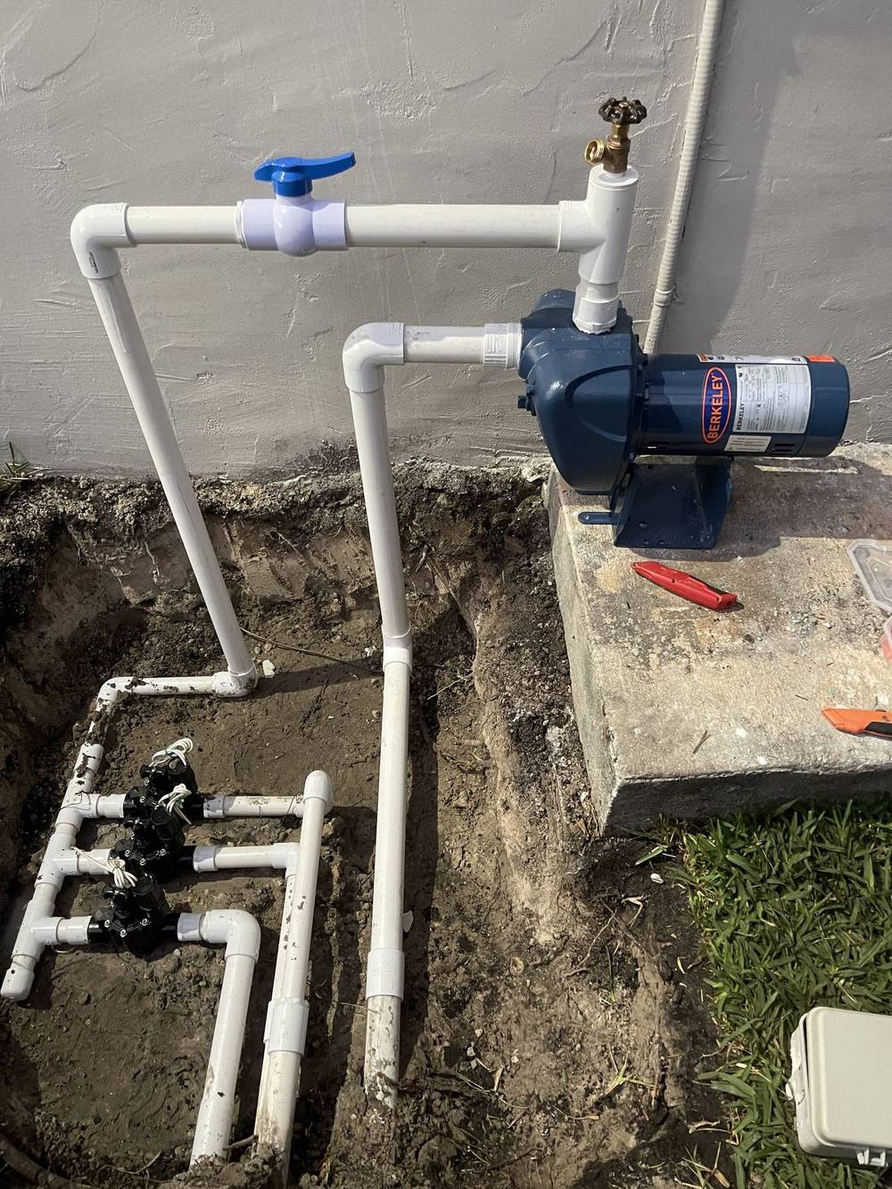 Old irrigation pipework exposed in an open trench